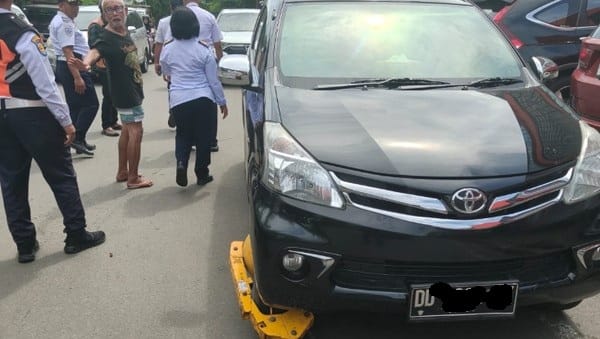 TEGAS. Dishub Makassar akhirnya mengambil tindakan tegas dengan menggembok kendaraan yang melanggar parkir di depan toko Alaska di Jalan Pengayoman, Makassar.