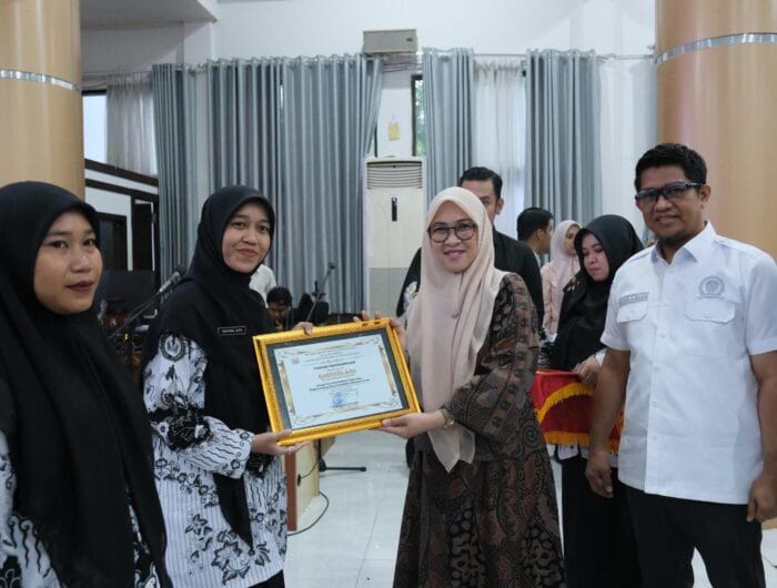 DEDIKASI. Bupati Gowa, Sitti Husniah Talenrang menyerahkan penghargaan kepada guru tebaik di Kabupaten Gowa.